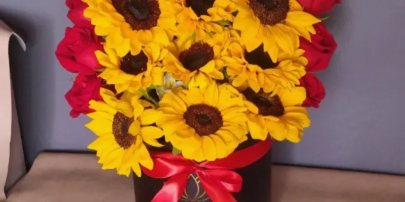 box with roses, sunflowers and chocolates