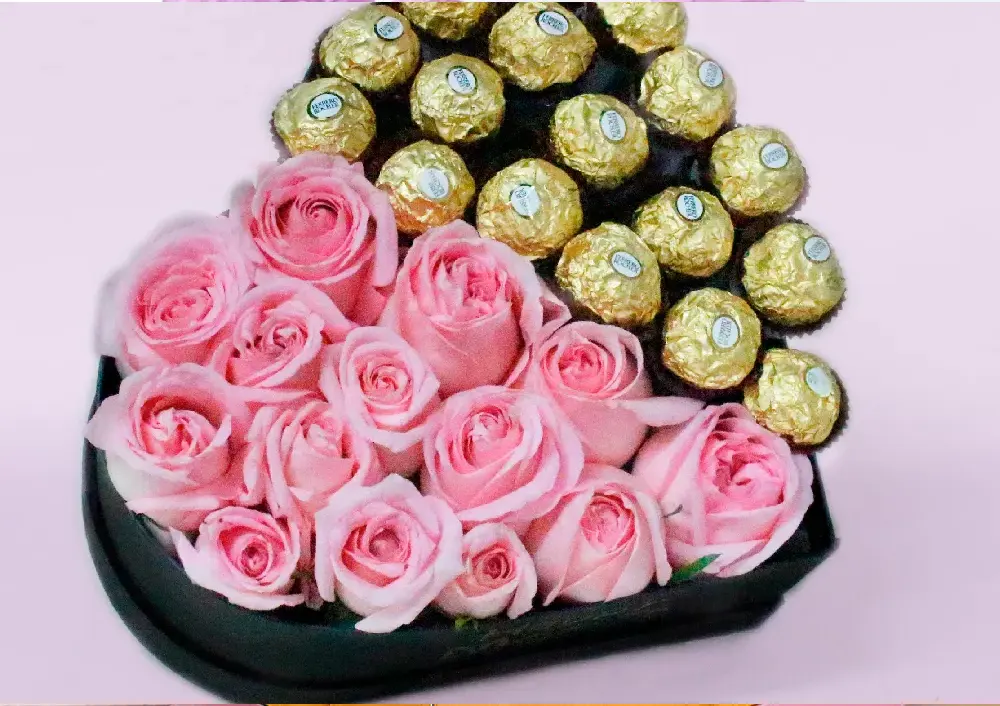 black heart-shaped box of chocolates ferrero rocher and pink roses