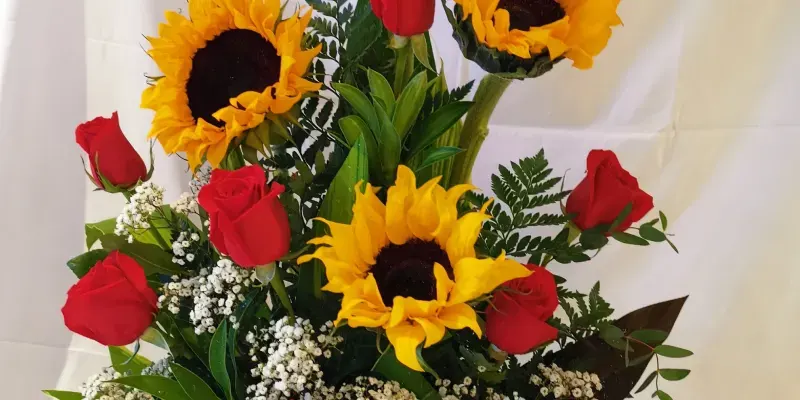 box of sunflowers, red roses and little clouds