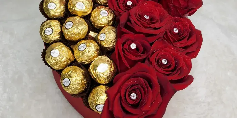 heart box of red roses with chocolates