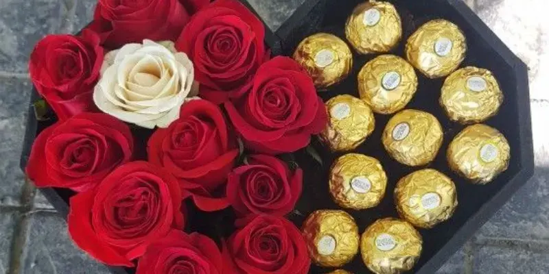 red roses with ferrero chocolates in a heart box