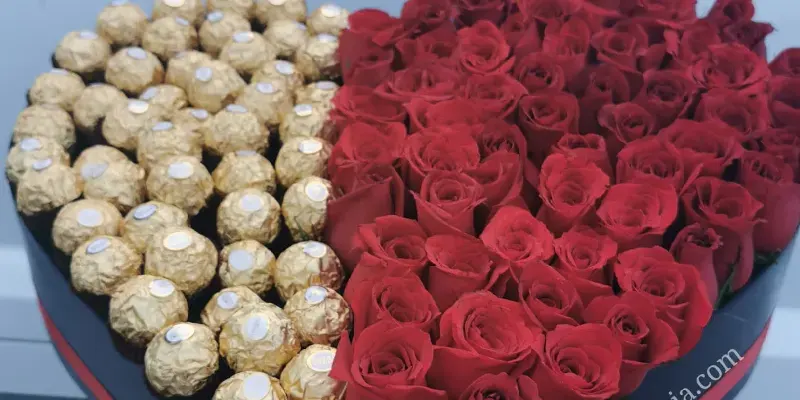 box of chocolates with roses in the shape of a big heart